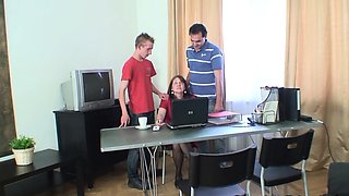 Redhead granny and teen boys have hot office 3some