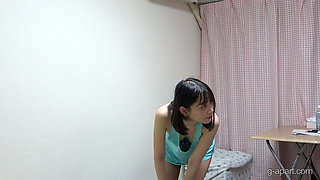Slim japanese girl is nude in her room and wears a camisole that shows her side boobs