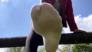 Outdoor solo masturbation scene with curly blonde