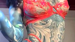 Big boobed tattooed seductress posing in sexy red lingerie