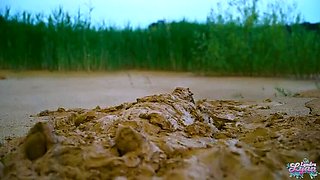 German teen masturbates to orgasm in muddy lake - wet and messy solo fingering