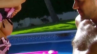 Brunette in corset fucking next to a pool