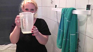 Pissing in jug- drinks and pours it on herself